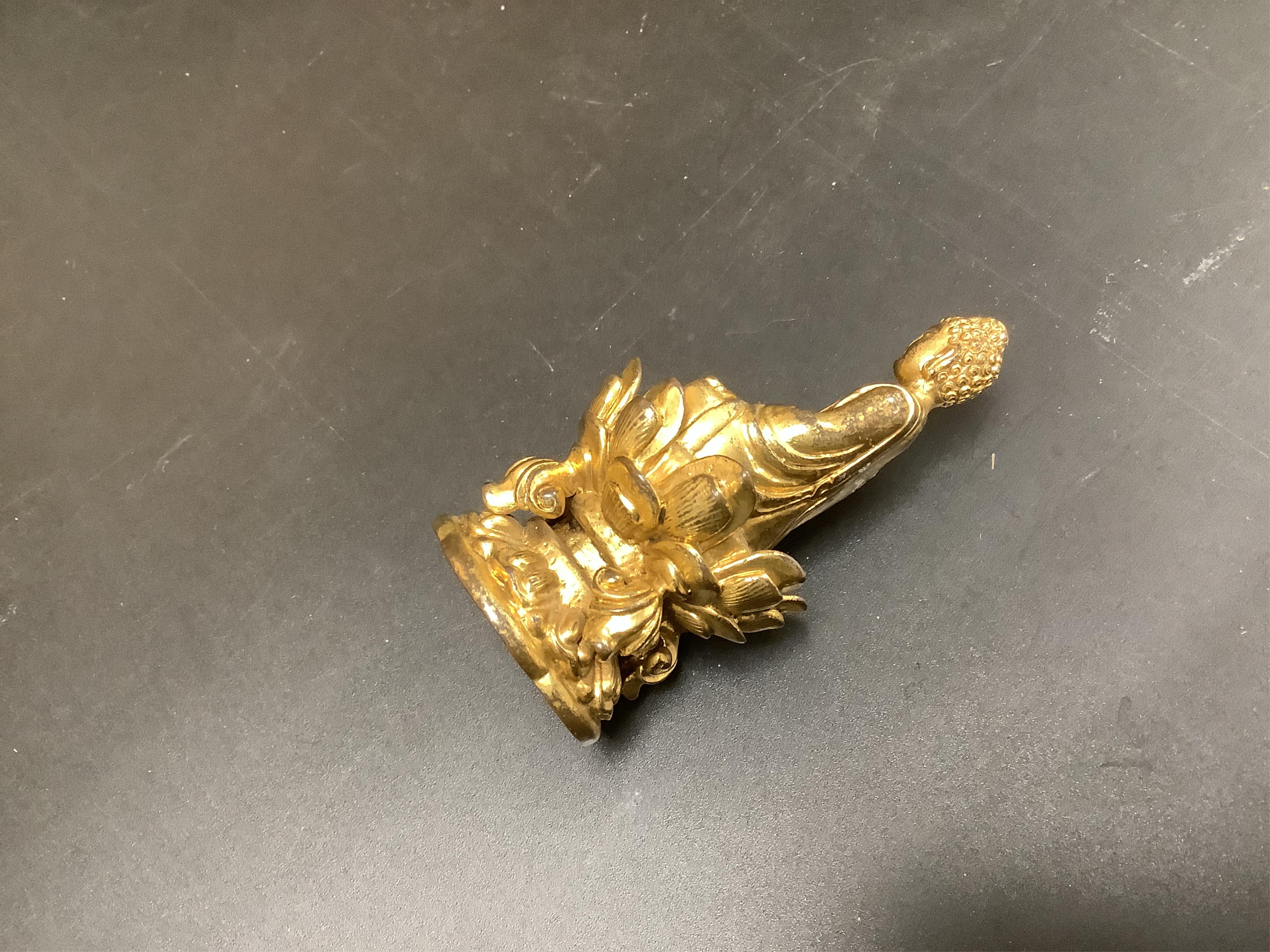 A Chinese miniature gilt metal figure of seated Buddha, 8cm high